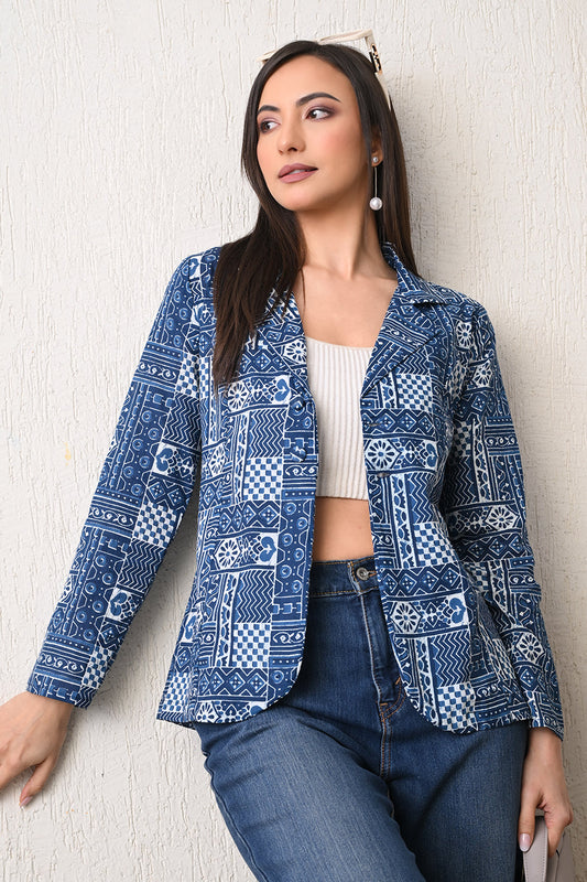 Woman wearing a blue patterned jacket against a light background from Desi Tassels
