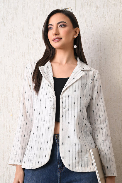 Woman wearing a white patterned jacket from Desi Tassels against a neutral background