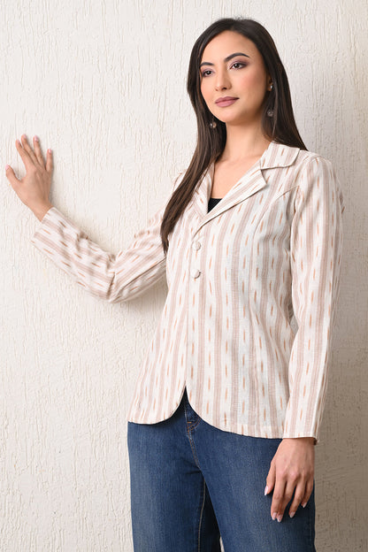 Woman wearing a striped shirt and blue jeans against a plain background from Desi Tassels