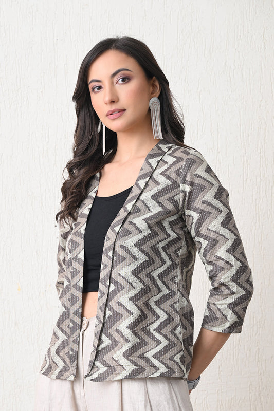 Woman wearing a patterned jacket from Desi Tassels against a white background